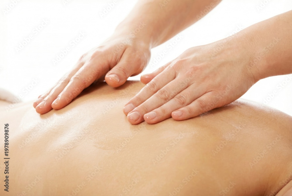 Naklejka premium Close up of professional hands applying oil and massaging the bare back of a client