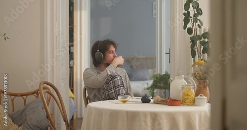 A relaxed morning unfolds with a tranquil setting, soft music, warm tea, and a cozy ambiance by the window