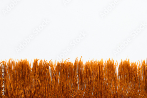 Valokuva Macro shot of vibrant orange yarn fringe on decorative textile cloth