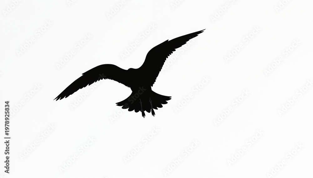 Fototapeta premium Black seagull silhouette flies against bright white sky. Bird wings are spread wide in motion. Simple, clean graphic image for various design uses.