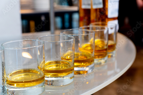 Wallpaper Mural Row of glasses filled with amber whiskey Torontodigital.ca