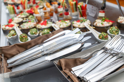 Wallpaper Mural Stainless steel cutlery set with forks and knives on a tray Torontodigital.ca