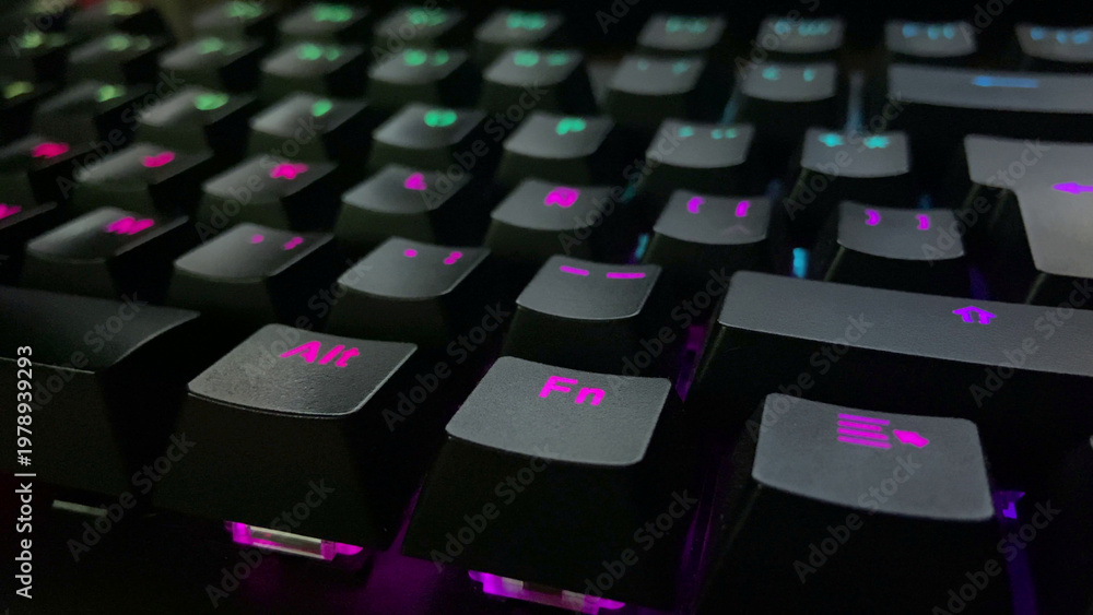 Obraz premium Mechanical gaming keyboard with vibrant pink and teal RGB backlighting