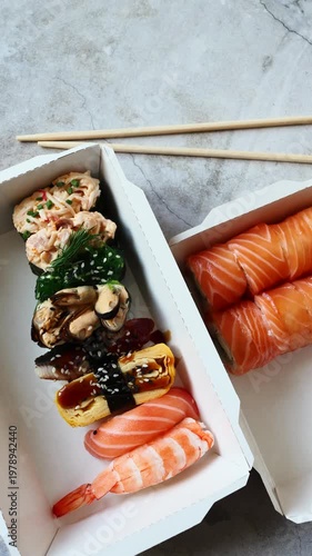 Freshly prepared sushi sits in two takeout boxes, showcasing vibrant colors and textures against a unique marble backdrop.