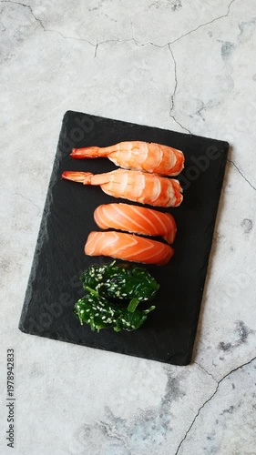Enjoy a stunning sushi display with fresh salmon and vibrant seaweed on a chic slate platter, perfect for sushi fans.