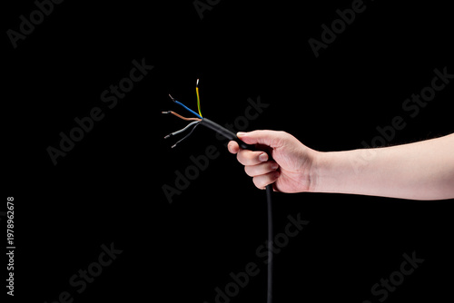 Fotografie Hand holding stripped cable close up