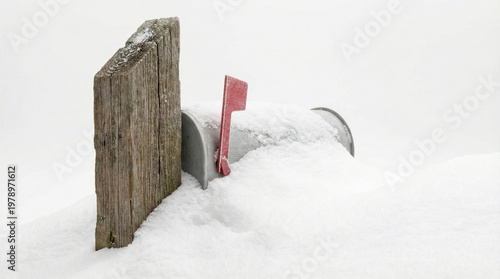 Snow covers mailbox and wooden post during winter storm creating quiet and cold atmosphere with soft white snow blanketing scene
