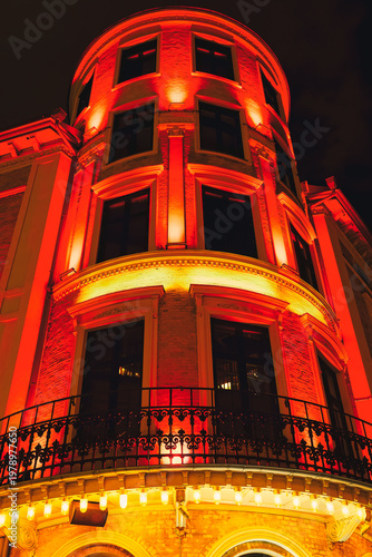 Traditional circular building in Gothenburg, Sweden, illuminated in bright red at night
