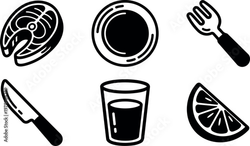 Fish steak plate knife fork glass and lemon slice