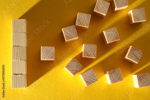 Many blank wooden cubes on yellow background, flat lay. Space for text