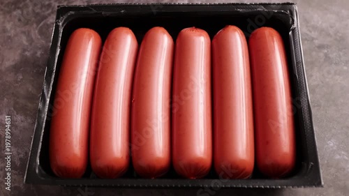 Freshly packed hot dogs ready for grilling at a summer barbecue gathering