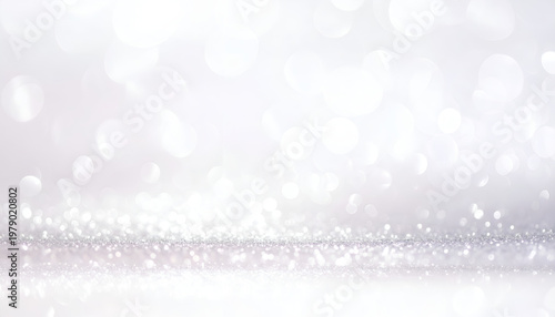 A shimmering, abstract background features a soft, blurred bokeh effect with a sparkling glitter texture along the bottom edge, creating a dreamy and ethereal atmosphere.