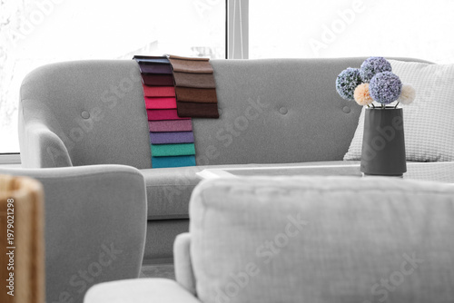Grey sofa with fabric sampl...
