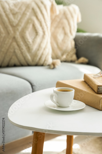 Cup of coffee with books on...