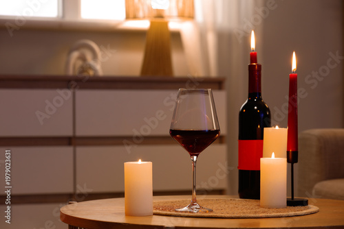 Red wine with burning candl...