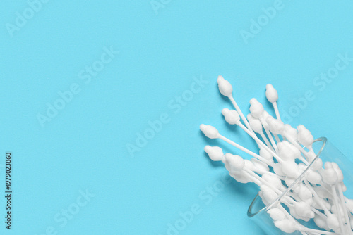 Glass with cotton buds on b...