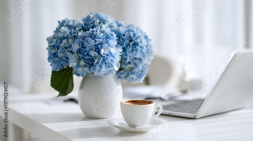 A scene featuring hydrangeas in a vase and a laptop on a table.