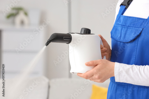 Female janitor with steam c...