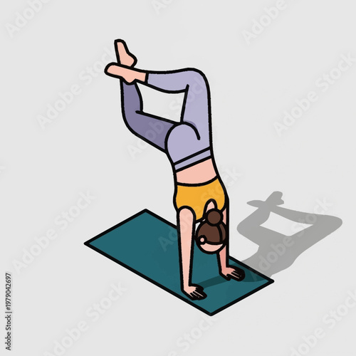 Woman performing handstand yoga on mat.