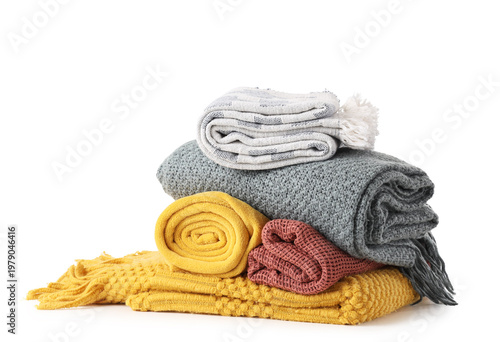 Stack of cozy blankets on w...