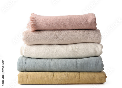 Stack of cozy blankets on w...
