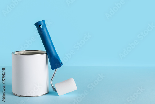 Can of paint and roller on ...