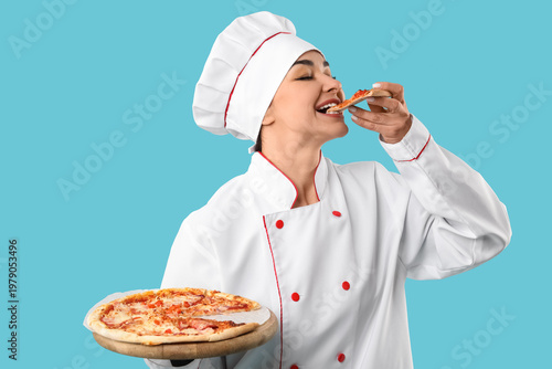 Female chef eating tasty pi...
