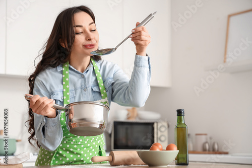 Beautiful woman tasting sou...