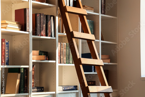 Wooden ladder near bookshel...