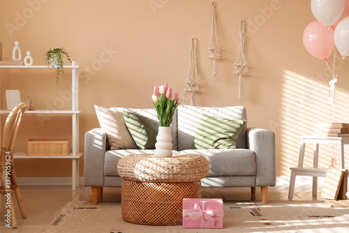 Interior of living room with sofa and tulips for Women's Day