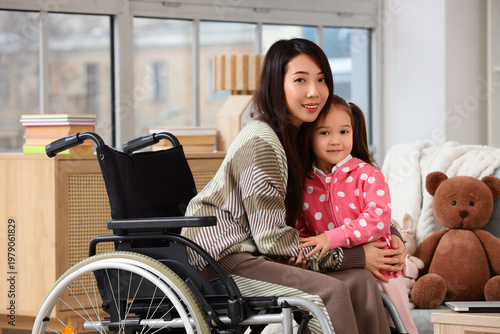 Young Asian mother in wheel...