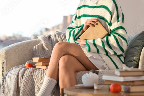 Young woman with books sitt...