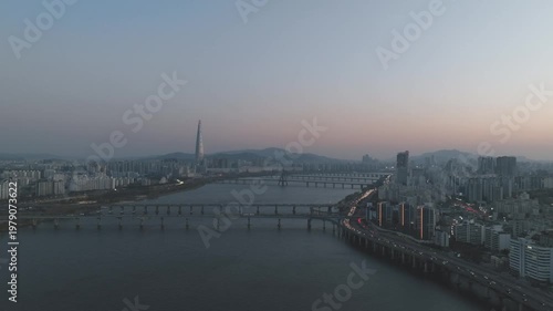 Aerial night view of the illuminated Seoul skyline and Han River from Gwangjin-gu, South Korea.