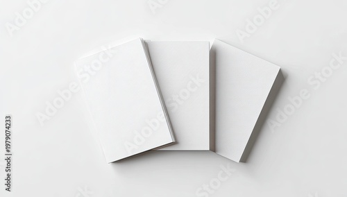 Three blank white rectangular cards fanned out on a white surface