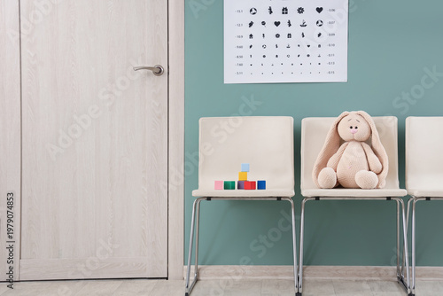 Toy bunny with cubes on chairs in pediatrician's hall