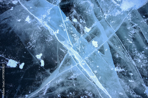 Beautiful cracks surface of the frozen lake of Baikal lake with frost methane bubbles in winter season. Baikal is the largest freshwater lake and the world's deepest lake.