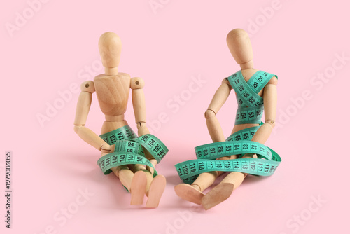 Wooden mannequins with gree...