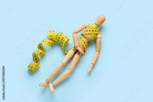 Wooden mannequin with yello...