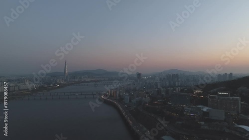 Aerial night view of the illuminated Seoul skyline and Han River from Gwangjin-gu, South Korea.