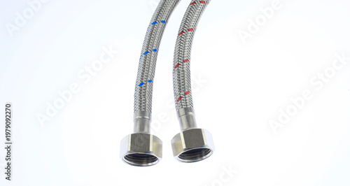 Metallic flexible hose with braided texture and threaded ends. White background emphasizes product details clearly.  plumbing hoses featuring, female threaded connectors isolated on white background. 