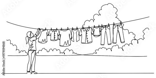 A woman hanging clean laundry out to dry on a clothesline on a bright and sunny afternoon day