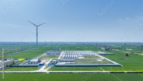 Wallpaper Mural Large-Scale Battery Energy Storage Station in Rural Farmland with Wind Turbine Background Torontodigital.ca