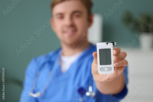 Male doctor with glucometer...
