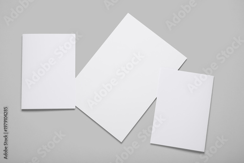 Blank white brochures on gr...