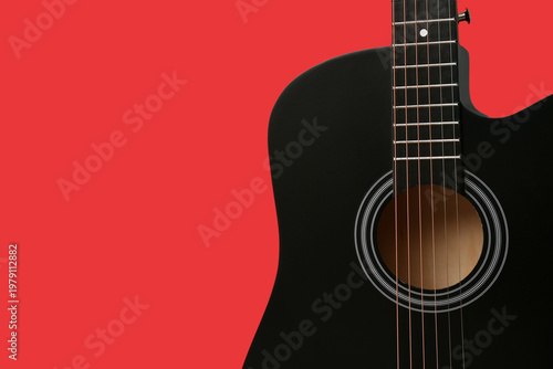 Modern black guitar on red ...