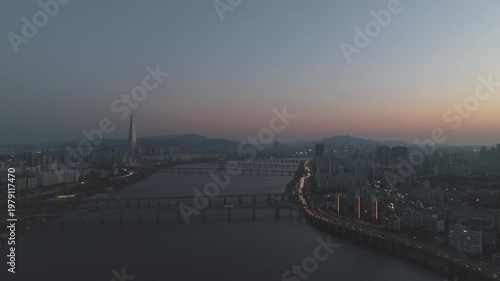 Aerial night view of the illuminated Seoul skyline and Han River from Gwangjin-gu, South Korea.