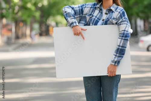 Young woman pointing at bla...