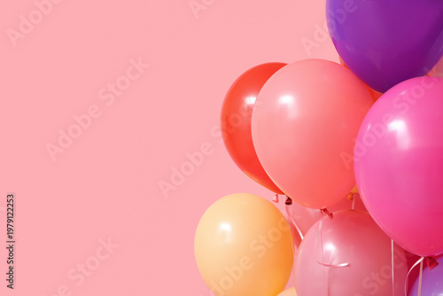 Colorful air balloons on pink background