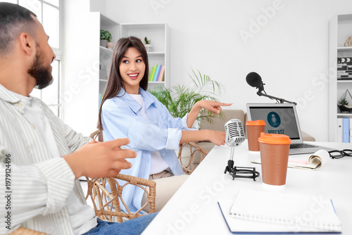 Young couple recording podc...