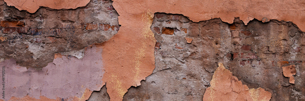 Fototapeta premium Old wall with cracked plaster. Weathered rough surface. Wide panoramic texture for background and design.
